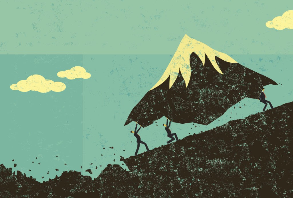 business men moving a mountain
